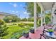 Inviting front porch with brick flooring, white columns, and comfortable seating, perfect for relaxing outdoors at 624 Richmond Street, Orlando, FL 32806