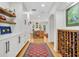 Hallway with hardwood floors, white cabinets and a large wine rack at 624 Richmond Street, Orlando, FL 32806