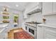 A modern kitchen with stainless steel appliances and white cabinets and countertops at 624 Richmond Street, Orlando, FL 32806