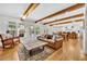 Open-concept living room with wood beams, hardwood floors, and backyard view at 624 Richmond Street, Orlando, FL 32806
