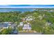 An aerial view shows this house with the lake and mature trees surrounding the property at 6501 Matchett Rd, Belle Isle, FL 32809