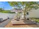 Backyard patio with lounge chairs under a striped umbrella surrounded by landscaping at 6501 Matchett Rd, Belle Isle, FL 32809