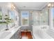 Bright bathroom with dual sinks, garden tub, and walk-in shower at 6501 Matchett Rd, Belle Isle, FL 32809