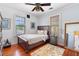 Cozy bedroom with hardwood floors, area rug and three windows for great natural light at 6501 Matchett Rd, Belle Isle, FL 32809