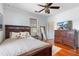 Bedroom with hardwood floors, ceiling fan, and large dark wood furniture set at 6501 Matchett Rd, Belle Isle, FL 32809