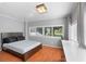 Bright bedroom with hardwood floors, large windows, and neutral decor at 6501 Matchett Rd, Belle Isle, FL 32809