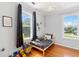 Bright bedroom features hardwood floors and windows with backyard views at 6501 Matchett Rd, Belle Isle, FL 32809