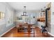 Charming dining room with wood floors, a rustic table, and a view into the kitchen at 6501 Matchett Rd, Belle Isle, FL 32809