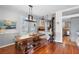 Inviting dining room with a rustic wooden table, bench seating, and a cozy wood-burning stove at 6501 Matchett Rd, Belle Isle, FL 32809