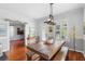 Elegant dining room featuring a wooden table, bench seating, and stylish decor at 6501 Matchett Rd, Belle Isle, FL 32809