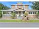 Charming two-story stone home with a metal roof, covered porch, and well-maintained landscaping at 6501 Matchett Rd, Belle Isle, FL 32809