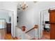 Upstairs hallway showcasing hardwood floors and access to various rooms at 6501 Matchett Rd, Belle Isle, FL 32809