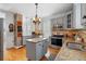 Open-concept kitchen featuring granite countertops, stainless appliances, and an island at 6501 Matchett Rd, Belle Isle, FL 32809