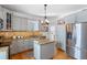 Well-appointed kitchen with granite countertops, stainless steel appliances, and custom cabinetry at 6501 Matchett Rd, Belle Isle, FL 32809