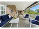 Inviting covered porch featuring stone accents, ample seating, and a tranquil outdoor ambiance at 6501 Matchett Rd, Belle Isle, FL 32809