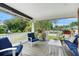 Relaxing covered porch with comfortable seating, potted plants, and a view of the neighborhood at 6501 Matchett Rd, Belle Isle, FL 32809