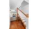 View of the staircase and living room with a fireplace at 6501 Matchett Rd, Belle Isle, FL 32809