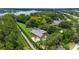 Aerial view of a sprawling property featuring a large home, lush landscaping, and a serene lake nearby at 6720 Winter Garden Vineland Rd, Windermere, FL 34786