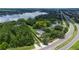Tranquil aerial perspective showcasing a private estate with a pool, pond, and a canopy of mature trees at 6720 Winter Garden Vineland Rd, Windermere, FL 34786
