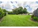 Expansive backyard featuring lush green grass and a mature tree line at 6720 Winter Garden Vineland Rd, Windermere, FL 34786
