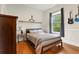 Bedroom featuring hardwood floors, model airplanes and guitars on the wall at 6720 Winter Garden Vineland Rd, Windermere, FL 34786
