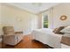Bright bedroom features hardwood floors, a comfortable chair, and closet storage space at 6720 Winter Garden Vineland Rd, Windermere, FL 34786