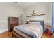 Bedroom with hardwood floors, a striped bedspread, and airplane decor on the wall at 6720 Winter Garden Vineland Rd, Windermere, FL 34786