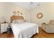 Bright bedroom features a wooden headboard, hardwood floors, and natural light at 6720 Winter Garden Vineland Rd, Windermere, FL 34786