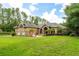 Charming home with stone accents, arched windows, and beautifully landscaped front yard at 6720 Winter Garden Vineland Rd, Windermere, FL 34786