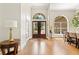 Grand foyer with wood floors, arched doorways, and views to the front yard at 6720 Winter Garden Vineland Rd, Windermere, FL 34786