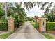 Gated driveway with meticulously maintained landscaping leading to the stunning home at 6720 Winter Garden Vineland Rd, Windermere, FL 34786