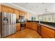 Modern kitchen features stainless steel appliances, wood cabinets and granite countertops at 6720 Winter Garden Vineland Rd, Windermere, FL 34786