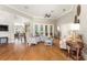 Spacious living room with high ceilings, stone fireplace, and hardwood floors, offering lots of natural light at 6720 Winter Garden Vineland Rd, Windermere, FL 34786