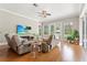 Bright living room with recliner sofas, large TV, and views of the screened-in patio at 6720 Winter Garden Vineland Rd, Windermere, FL 34786