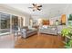 Open-concept living room with hardwood floors, sofas, and access to the pool area and kitchen at 6720 Winter Garden Vineland Rd, Windermere, FL 34786