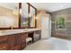 Primary bathroom features a double sink vanity, decorative lighting and tiled walk-in shower at 6720 Winter Garden Vineland Rd, Windermere, FL 34786