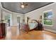 Main bedroom features a tray ceiling, wood floors and private access to the lanai at 6720 Winter Garden Vineland Rd, Windermere, FL 34786