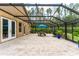 Covered patio area with a screened enclosure, offering outdoor dining and entertaining at 6720 Winter Garden Vineland Rd, Windermere, FL 34786