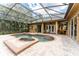 Beautiful pool area with lush landscaping and a screened enclosure, ideal for relaxation at 6720 Winter Garden Vineland Rd, Windermere, FL 34786
