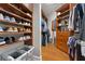 Custom walk-in closet with built-in shelving and cabinets to maximize storage at 6720 Winter Garden Vineland Rd, Windermere, FL 34786