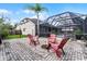 Paver patio with fire pit, screened pool, and seating in the backyard of this lovely home at 806 Spring Island Way, Orlando, FL 32828