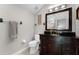 Elegant bathroom with a dark wood vanity, tiled floors, and a large mirror reflecting a shower at 806 Spring Island Way, Orlando, FL 32828