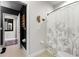 Well-lit bathroom with a decorative shower curtain and adjacent doorway showing the next room at 806 Spring Island Way, Orlando, FL 32828