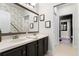 Elegant bathroom with a double vanity, ornate mirror, and decorative wallpaper at 806 Spring Island Way, Orlando, FL 32828