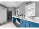 Bright bathroom featuring a double vanity, white countertops, and stylish blue cabinets, complemented by modern fixtures at 806 Spring Island Way, Orlando, FL 32828