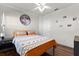 Cozy bedroom with a colorful bedspread, wood floors, and natural light from the window at 806 Spring Island Way, Orlando, FL 32828