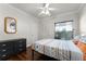 Comfortable bedroom with a patterned bedspread, wood floors, and plenty of natural light at 806 Spring Island Way, Orlando, FL 32828
