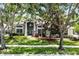 Charming home featuring a manicured lawn, mature trees, and a welcoming front entrance at 806 Spring Island Way, Orlando, FL 32828