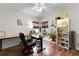 Inviting home office with wood floors, natural light, and multiple desks with a ceiling fan at 806 Spring Island Way, Orlando, FL 32828