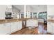 Open kitchen design with stainless steel appliances, white cabinets and wooden floors at 806 Spring Island Way, Orlando, FL 32828